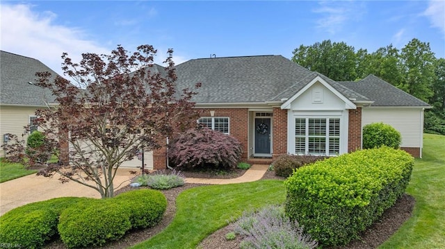 6943 Chancery Ln, Williamsburg, VA 23188 - view of front of property with brick siding, a front yard, and roof with shingles