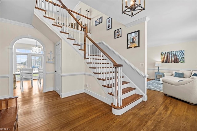 200 Congress Ave, Hampton, VA 23669 - stairway with a chandelier, wood finished floors, crown molding, baseboards, and arched walkways
