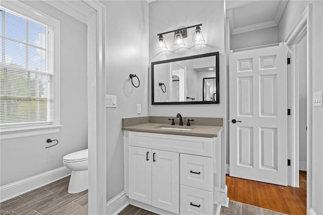200 Congress Ave, Hampton, VA 23669 - bathroom with vanity, baseboards, wood finished floors, plenty of natural light, and crown molding