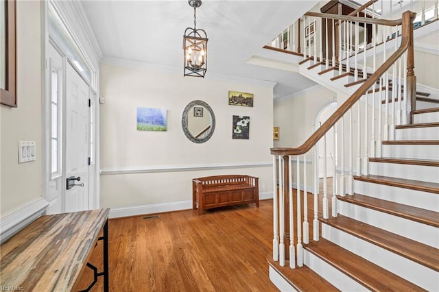 200 Congress Ave, Hampton, VA 23669 - foyer with stairway, crown molding, wood finished floors, a chandelier, and baseboards