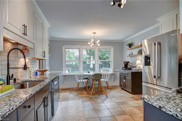 1005 Minden Rd, Virginia Beach, VA 23464 - kitchen featuring stainless steel appliances, a sink, decorative backsplash, a chandelier, and white cabinets