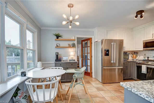 1005 Minden Rd, Virginia Beach, VA 23464 - kitchen with appliances with stainless steel finishes, crown molding, backsplash, white cabinetry, and decorative light fixtures
