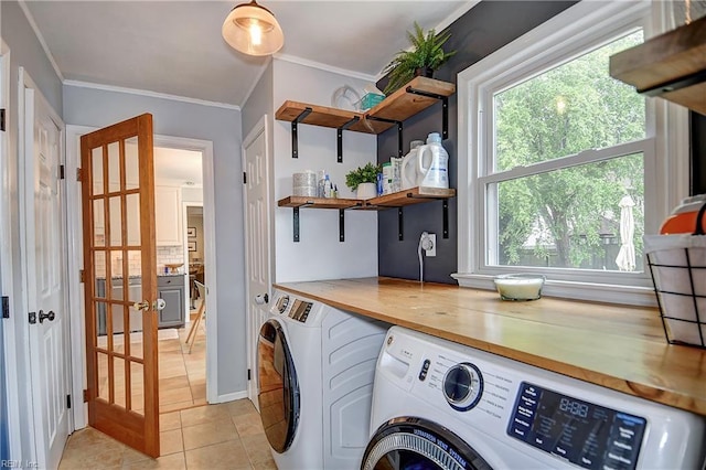 1005 Minden Rd, Virginia Beach, VA 23464 - washroom featuring washing machine and dryer, ornamental molding, light tile patterned floors, and baseboards