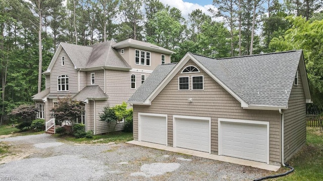 4437 Cherokee Dr, Suffolk, VA 23434 - view of front facade with roof with shingles, view of scattered trees, and a detached garage