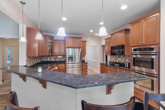4437 Cherokee Dr, Suffolk, VA 23434 - kitchen featuring black appliances, glass insert cabinets, backsplash, a breakfast bar area, and recessed lighting