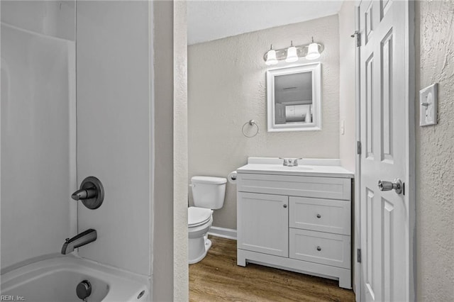 2105 Portlock Rd, Chesapeake, VA 23324 - full bath with vanity, toilet, wood finished floors, a textured wall, and bathing tub / shower combination