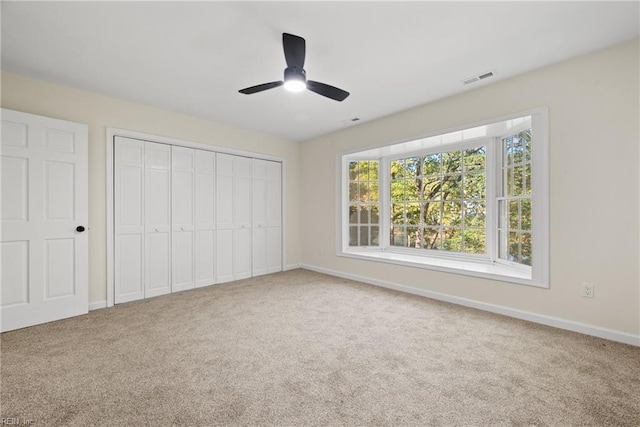 166 Windward Way, Port Haywood, VA 23138 - unfurnished bedroom with carpet floors, baseboards, a closet, and a ceiling fan