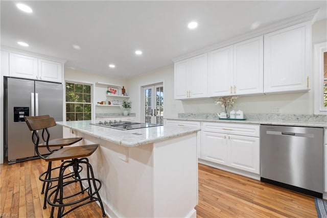 166 Windward Way, Port Haywood, VA 23138 - kitchen with appliances with stainless steel finishes, light wood-style floors, a kitchen island, recessed lighting, and white cabinets