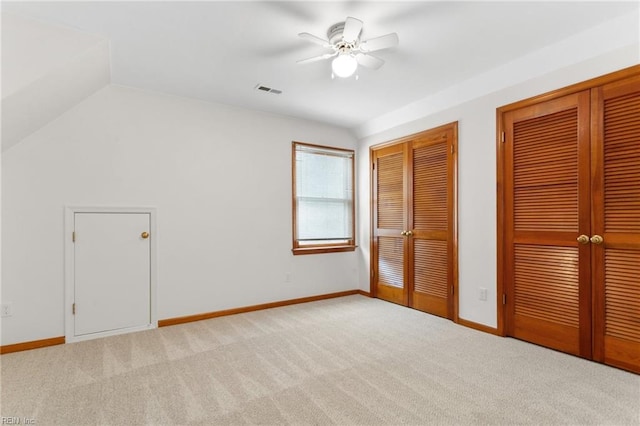 2543 Bridge Rd, Suffolk, VA 23435 - unfurnished bedroom with two closets, light carpet, baseboards, ceiling fan, and vaulted ceiling