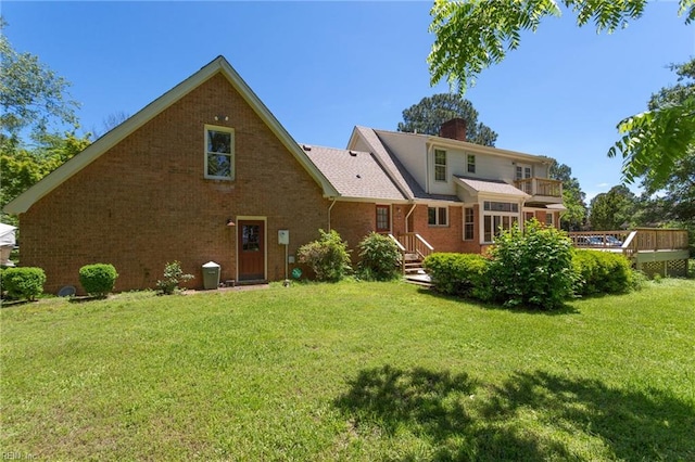 2543 Bridge Rd, Suffolk, VA 23435 - back of house with a yard, brick siding, a chimney, and a balcony
