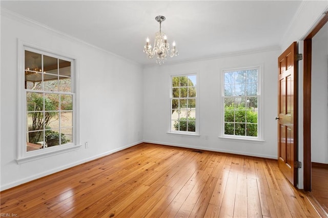 2543 Bridge Rd, Suffolk, VA 23435 - spare room featuring a chandelier, crown molding, light wood finished floors, and baseboards