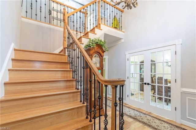 3512 Quail Holw, Williamsburg, VA 23185 - stairway with a high ceiling, french doors, wood finished floors, and a chandelier