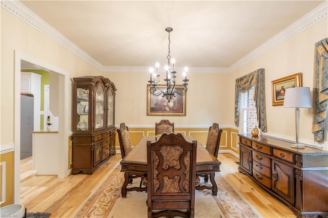 3512 Quail Holw, Williamsburg, VA 23185 - dining area featuring a chandelier, light wood-style flooring, crown molding, and wainscoting