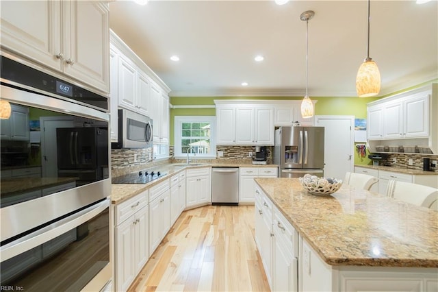 3512 Quail Holw, Williamsburg, VA 23185 - kitchen with stainless steel appliances, a sink, ornamental molding, white cabinets, and a center island