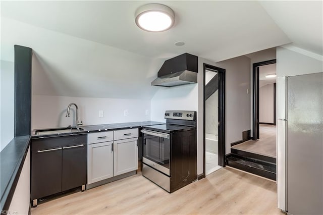 1943 Sycamore Ln, Norfolk, VA 23523 - kitchen featuring freestanding refrigerator, stainless steel range with electric cooktop, wall chimney range hood, a sink, and light wood-style floors