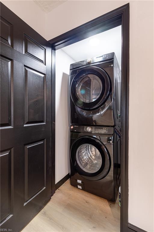 1943 Sycamore Ln, Norfolk, VA 23523 - washroom with stacked washer and clothes dryer, wood finished floors, and baseboards