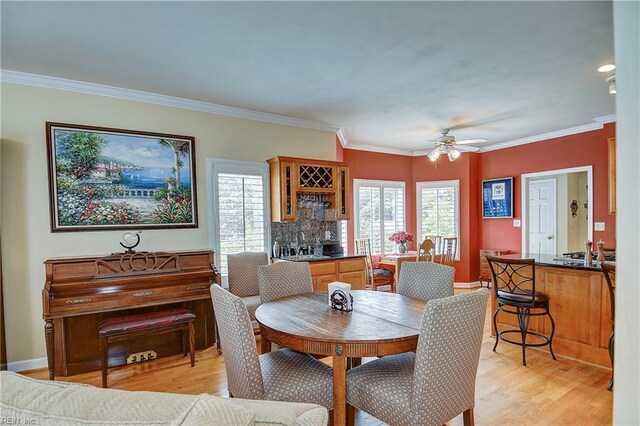 2637 Broad Bay Rd, Virginia Beach, VA 23451 - dining room with light wood-type flooring, a ceiling fan, crown molding, bar area, and baseboards