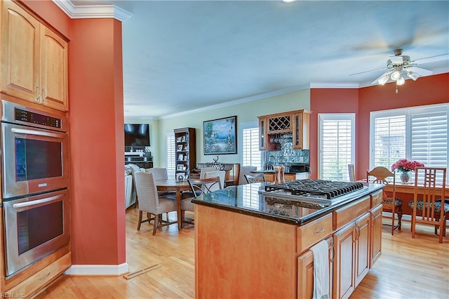 2637 Broad Bay Rd, Virginia Beach, VA 23451 - kitchen featuring stainless steel appliances, light wood-style flooring, ceiling fan, dark stone counters, and crown molding