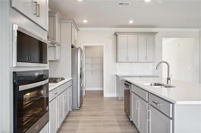 1232 Kidbrooke St, Chesapeake, VA 23322 - kitchen with appliances with stainless steel finishes, a sink, crown molding, light countertops, and light wood-type flooring