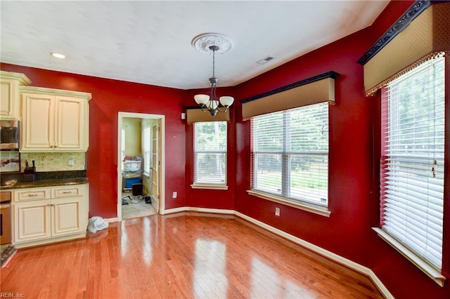 313 Queen Ct, Smithfield, VA 23430 - unfurnished dining area with healthy amount of natural light, a chandelier, light wood-type flooring, baseboards, and recessed lighting