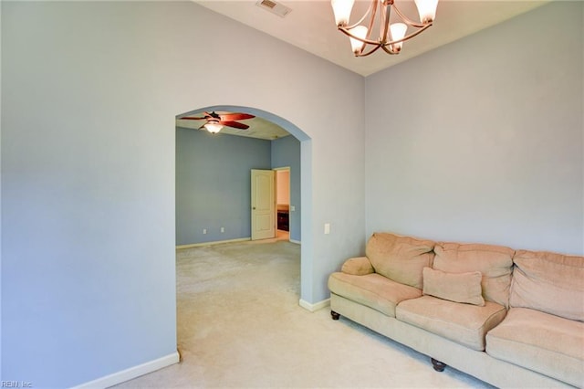 313 Queen Ct, Smithfield, VA 23430 - living area featuring light colored carpet, arched walkways, a chandelier, and baseboards