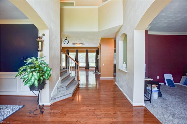 313 Queen Ct, Smithfield, VA 23430 - entryway with wood finished floors, stairs, arched walkways, crown molding, and baseboards