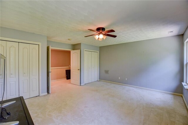 313 Queen Ct, Smithfield, VA 23430 - unfurnished bedroom featuring multiple closets, light carpet, and baseboards