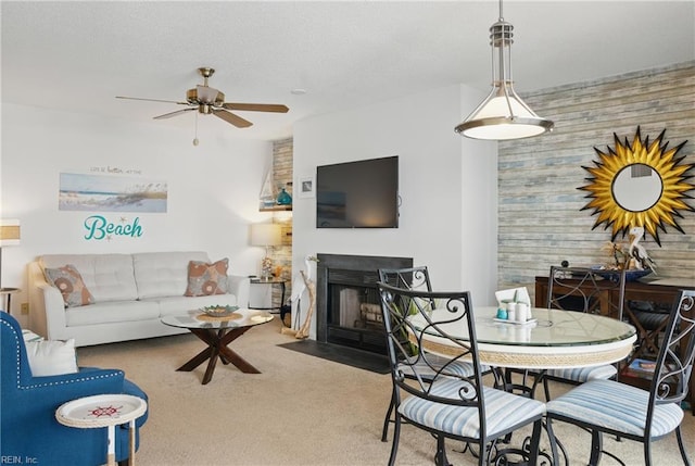 612 Shoreham Ct Unit 202, Virginia Beach, VA 23451 - carpeted dining room with a ceiling fan, wooden walls, and a fireplace with flush hearth