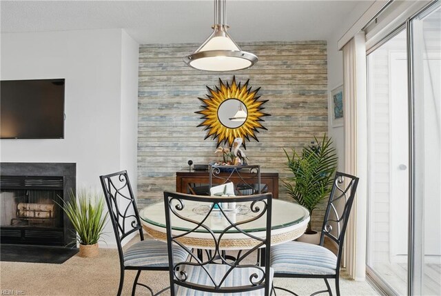 612 Shoreham Ct Unit 202, Virginia Beach, VA 23451 - dining space featuring carpet flooring, wooden walls, an accent wall, a fireplace with flush hearth, and baseboards