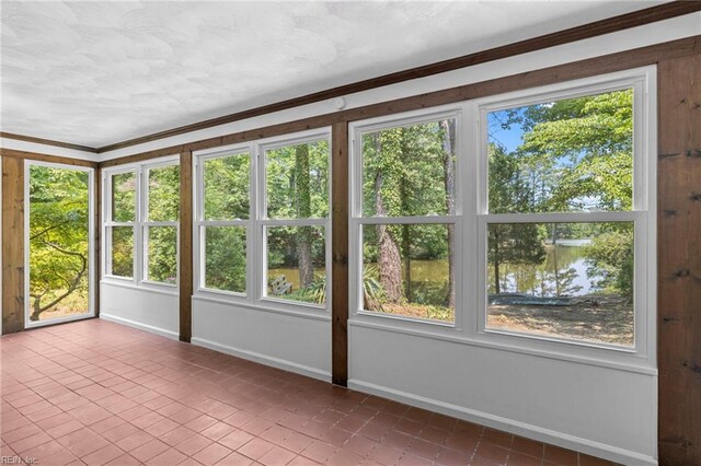 9 Hill Way, Carrollton, VA 23314 - unfurnished sunroom featuring a water view, tile patterned floors, baseboards, and crown molding