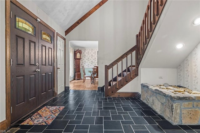 9 Hill Way, Carrollton, VA 23314 - entrance foyer with wallpapered walls, stairs, vaulted ceiling, and baseboards