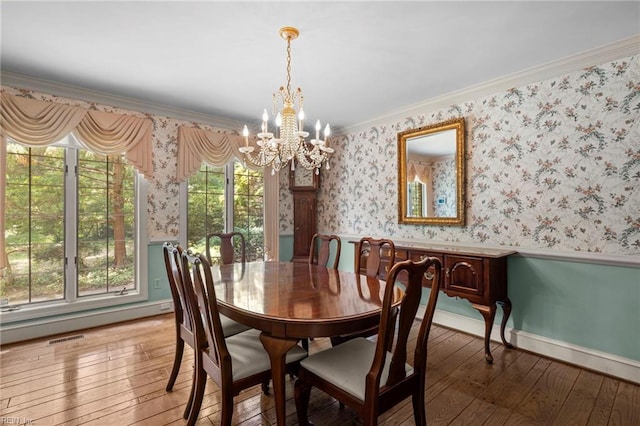 9 Hill Way, Carrollton, VA 23314 - dining space featuring a chandelier, light wood-style floors, a wainscoted wall, wallpapered walls, and ornamental molding