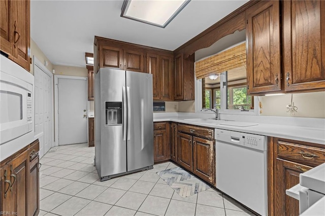 9 Hill Way, Carrollton, VA 23314 - kitchen with white appliances, a sink, light countertops, and light tile patterned flooring