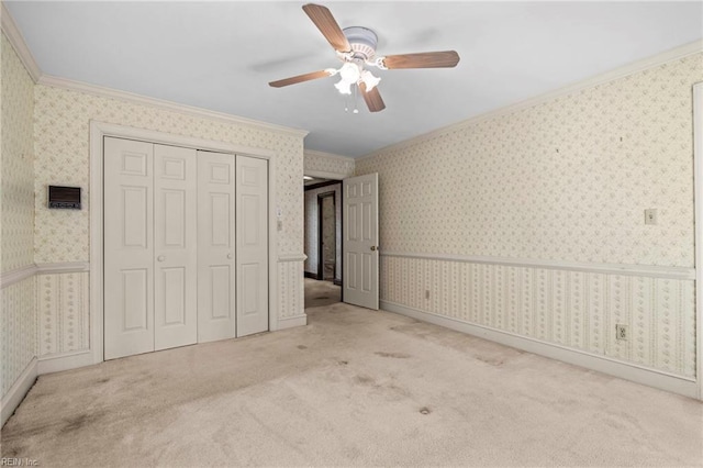 9 Hill Way, Carrollton, VA 23314 - unfurnished bedroom with ornamental molding, carpet, a closet, ceiling fan, and wallpapered walls
