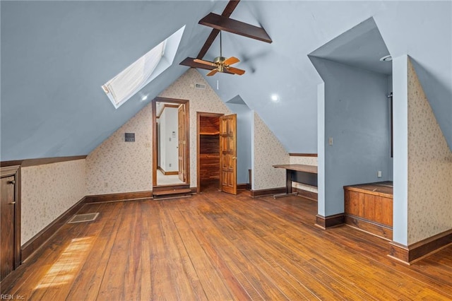 9 Hill Way, Carrollton, VA 23314 - bonus room featuring wallpapered walls, hardwood / wood-style floors, lofted ceiling, a ceiling fan, and a skylight