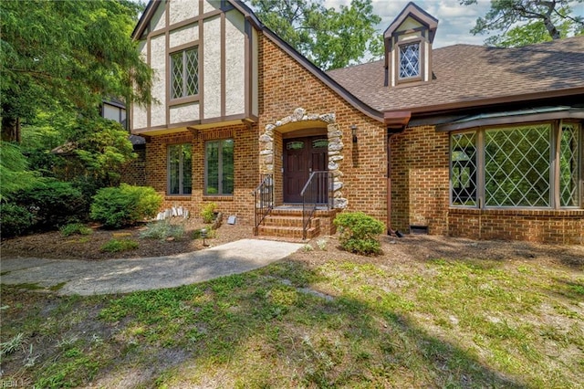 9 Hill Way, Carrollton, VA 23314 - english style home with brick siding, a shingled roof, and a front yard