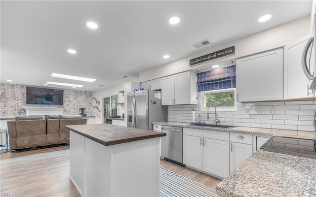 2012 Damascus Ct, Virginia Beach, VA 23453 - kitchen featuring appliances with stainless steel finishes, a sink, wood counters, a center island, and open floor plan