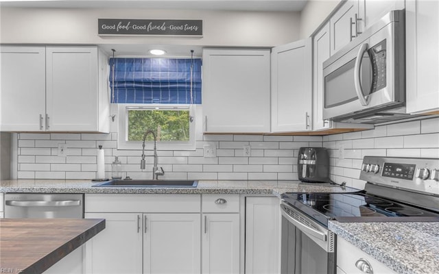 2012 Damascus Ct, Virginia Beach, VA 23453 - kitchen featuring stainless steel appliances, a sink, backsplash, and white cabinets
