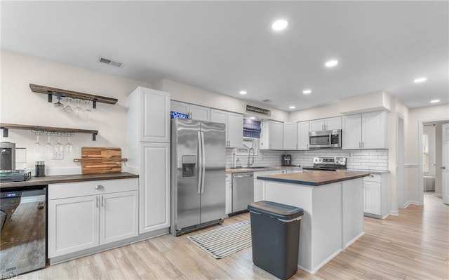 2012 Damascus Ct, Virginia Beach, VA 23453 - kitchen with appliances with stainless steel finishes, a sink, light wood-style floors, decorative backsplash, and wood counters