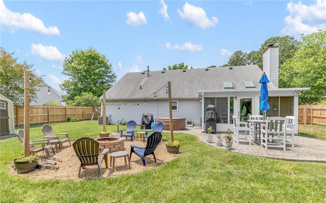 2012 Damascus Ct, Virginia Beach, VA 23453 - back of property with a hot tub, a sunroom, a patio, an outdoor fire pit, and roof with shingles