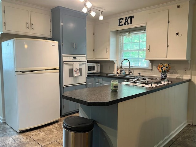 432 Crescent Dr, Franklin, VA 23851 - kitchen featuring white appliances, a sink, dark countertops, a peninsula, and light tile patterned flooring