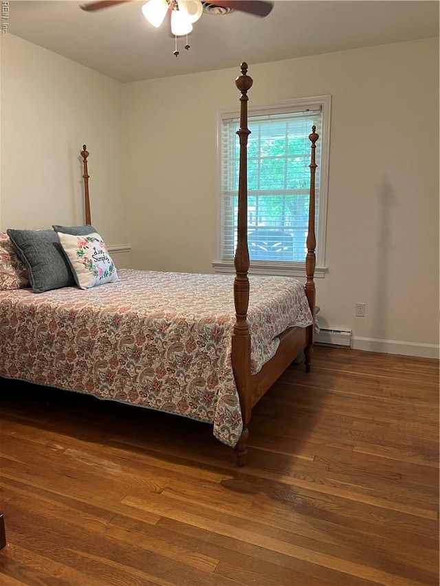 432 Crescent Dr, Franklin, VA 23851 - bedroom featuring a baseboard radiator, wood finished floors, baseboards, and a ceiling fan