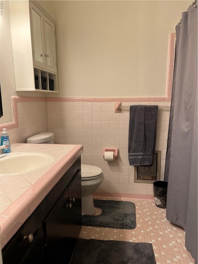 432 Crescent Dr, Franklin, VA 23851 - bathroom with vanity, toilet, a wainscoted wall, tile walls, and a shower with shower curtain