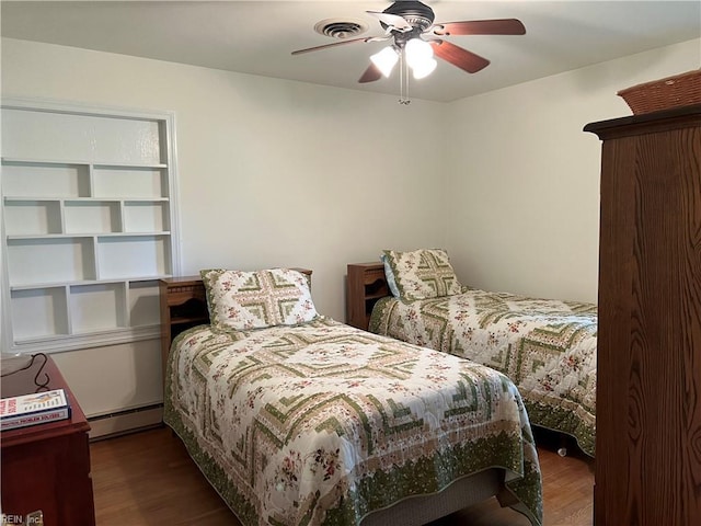 432 Crescent Dr, Franklin, VA 23851 - bedroom featuring baseboard heating, wood finished floors, and ceiling fan