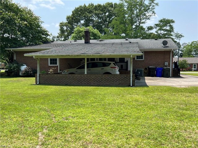 432 Crescent Dr, Franklin, VA 23851 - back of house with a lawn, brick siding, a chimney, and central air condition unit