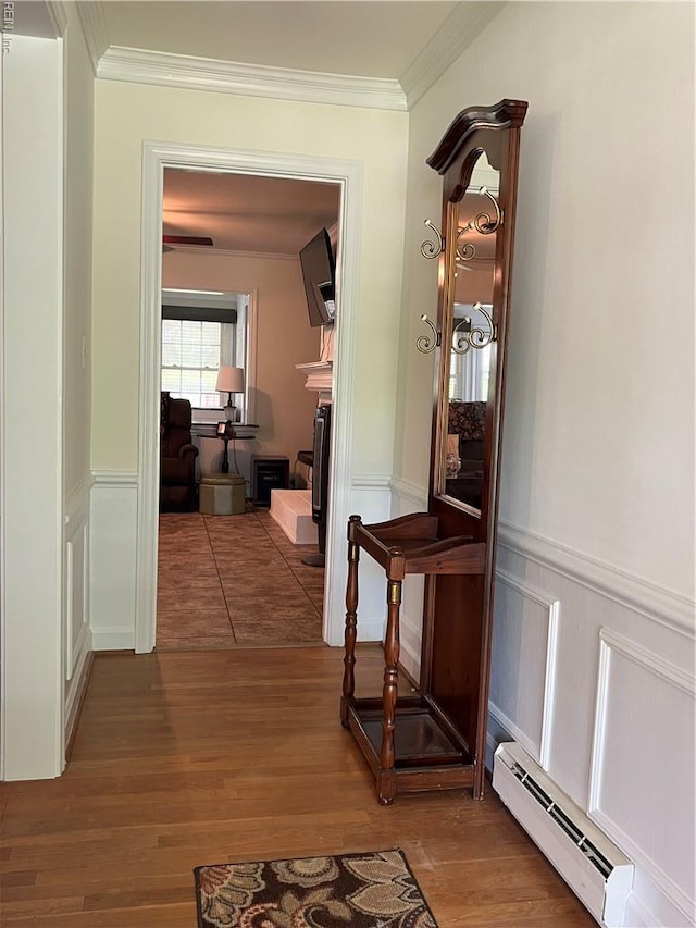 432 Crescent Dr, Franklin, VA 23851 - hallway featuring a baseboard radiator, wood finished floors, crown molding, wainscoting, and a decorative wall