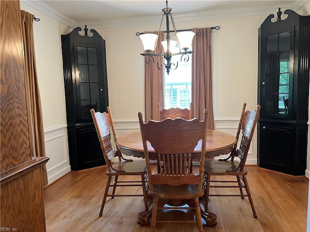 432 Crescent Dr, Franklin, VA 23851 - dining area featuring a chandelier, light wood-style floors, ornamental molding, a decorative wall, and wainscoting