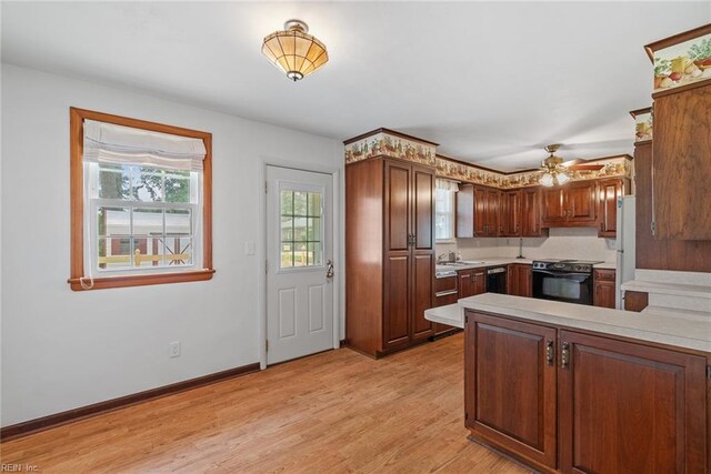 3435 Macdonald Rd, Virginia Beach, VA 23464 - kitchen with electric stove, light countertops, a sink, light wood-type flooring, and a peninsula