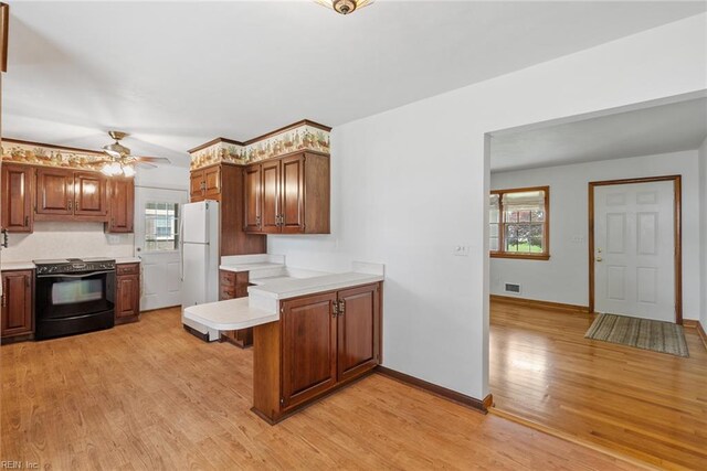 3435 Macdonald Rd, Virginia Beach, VA 23464 - kitchen with black / electric stove, freestanding refrigerator, a peninsula, and light countertops