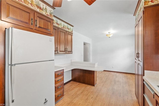 3435 Macdonald Rd, Virginia Beach, VA 23464 - kitchen featuring freestanding refrigerator, a peninsula, brown cabinets, and light countertops